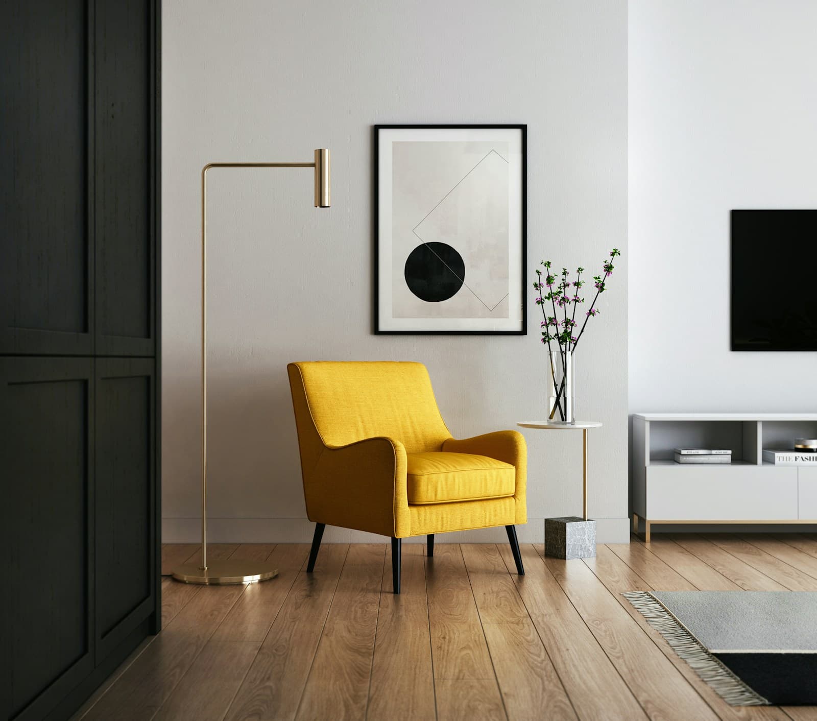 Mustard yellow accent chair beside a brass floor lamp, with a wall-mounted screen and low media unit