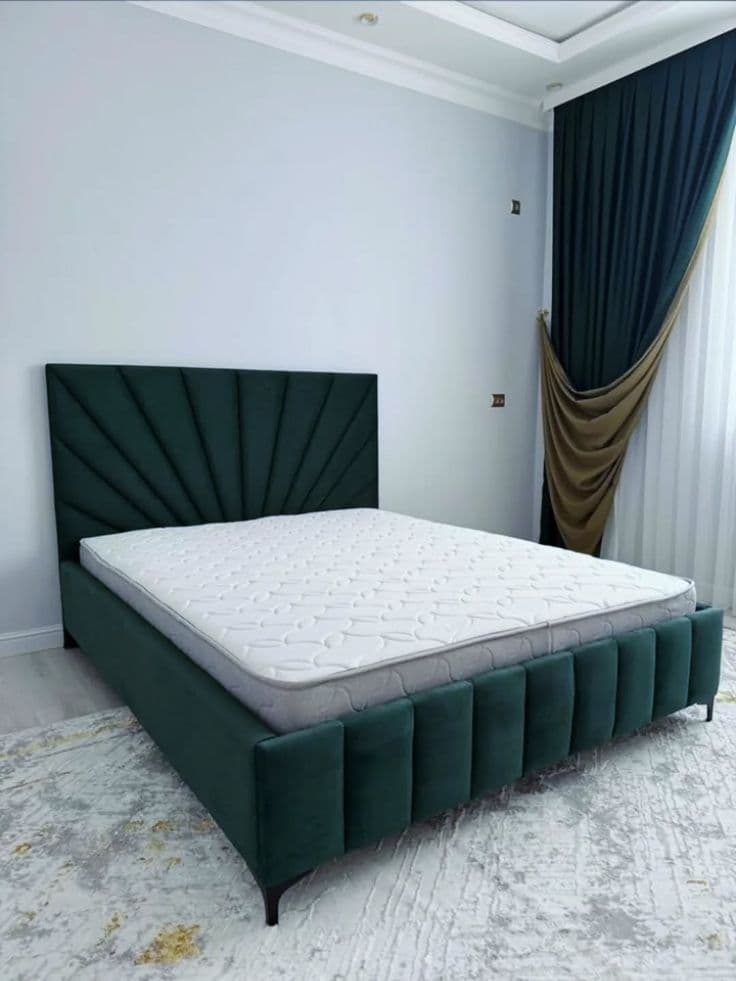 Bedroom with a dark green fan-tufted upholstered bed and gold-trimmed curtains