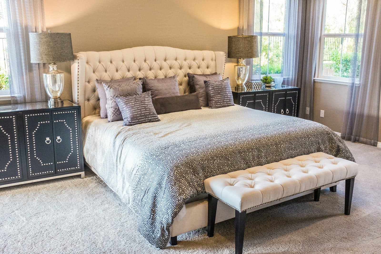 Classic button tufted cream headboard bed dressed with layered bedding