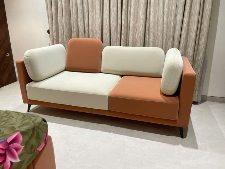 Terracotta and ivory two-tone two-seater sofa in the showroom