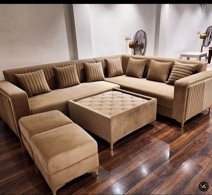 Teal and ivory two-tone L-shaped sectional sofa with a round tufted ottoman, in the showroom