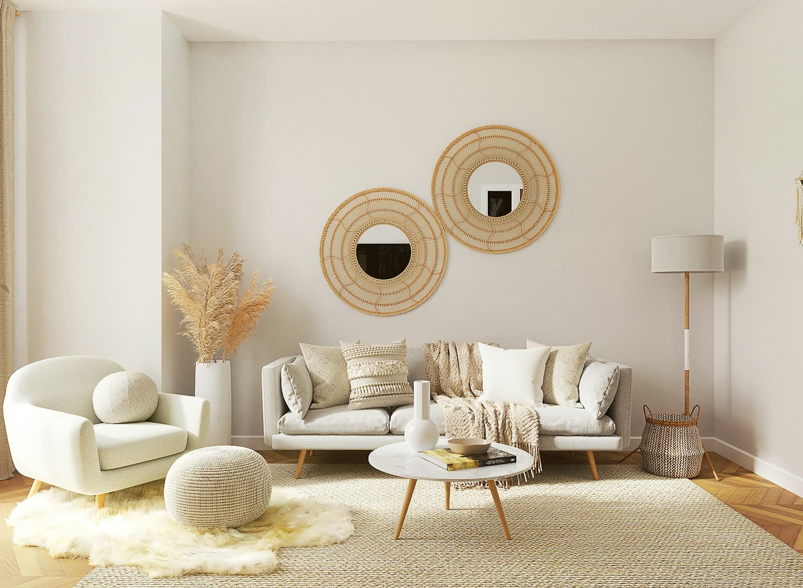Cream three-seater sofa and a boucle armchair around a round marble centre table in a pale living room